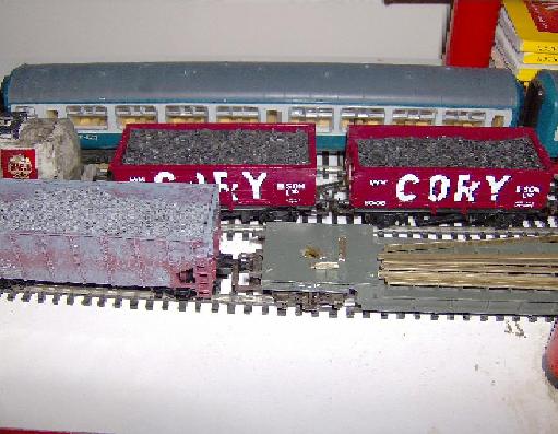 two cory trucks and a gravel hopper